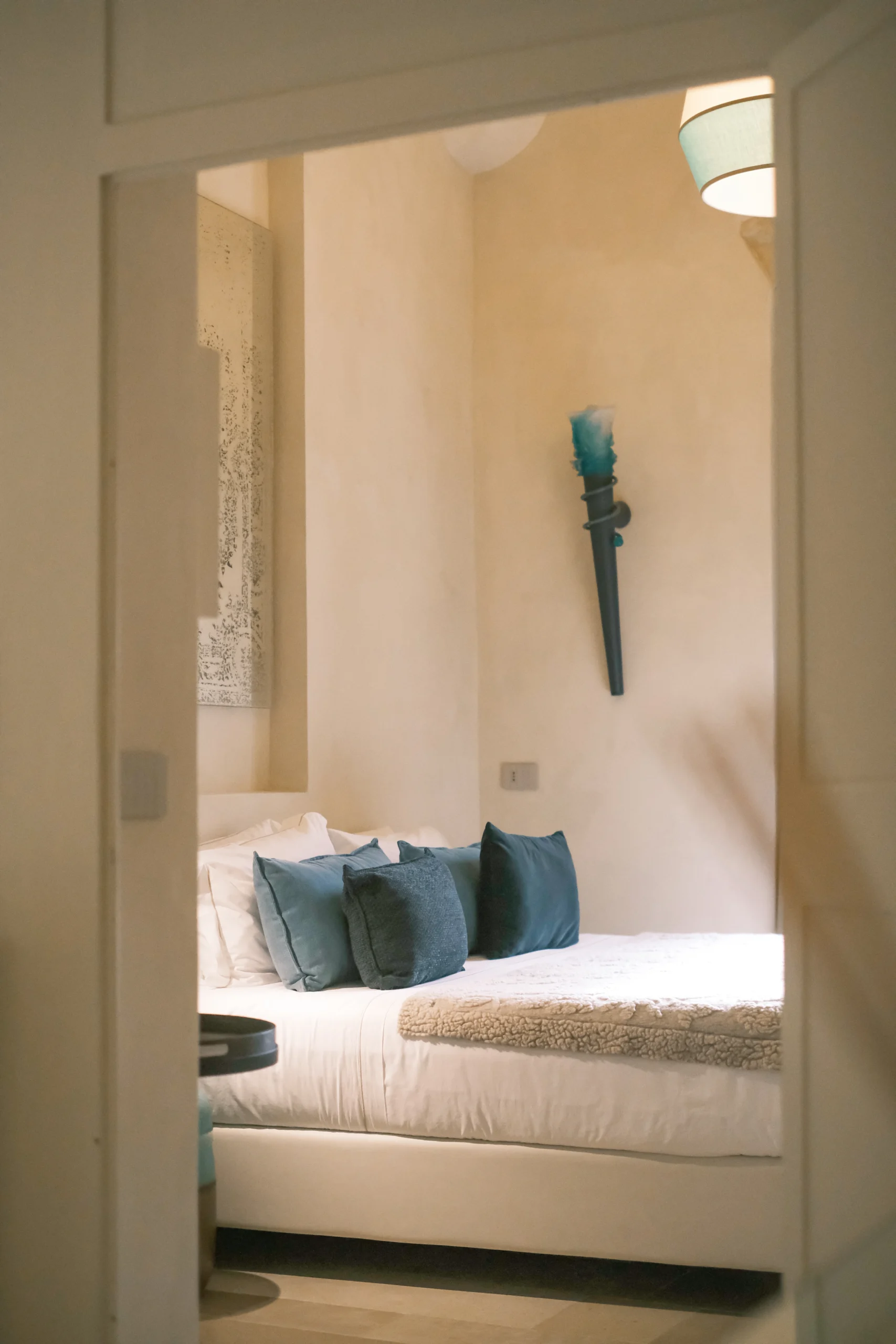 Luxury bedroom with custom headboard, warm textures, and minimalist Italian design