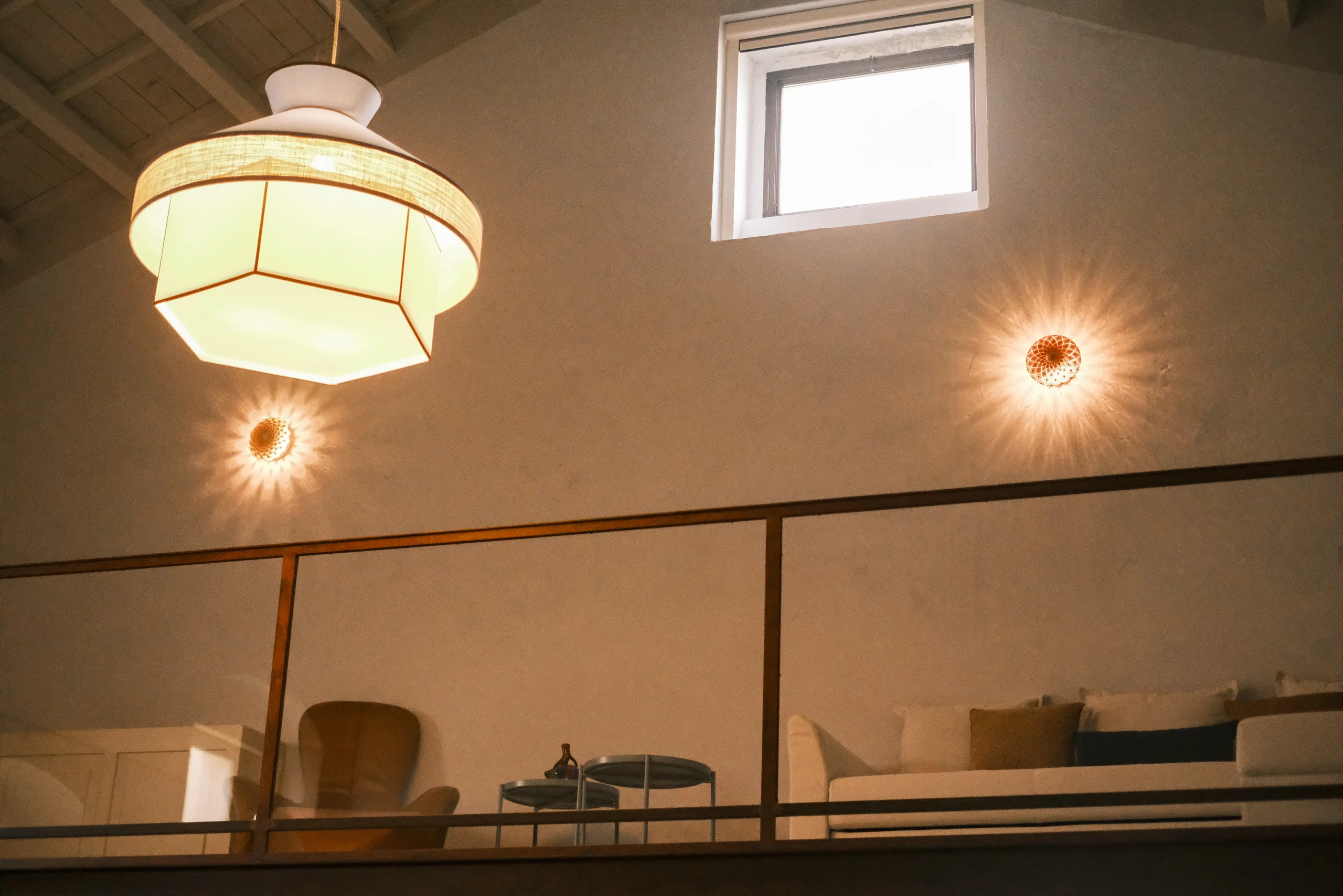 Mezzanine bedroom view with designer lighting and lounge area in a luxury Italian villa