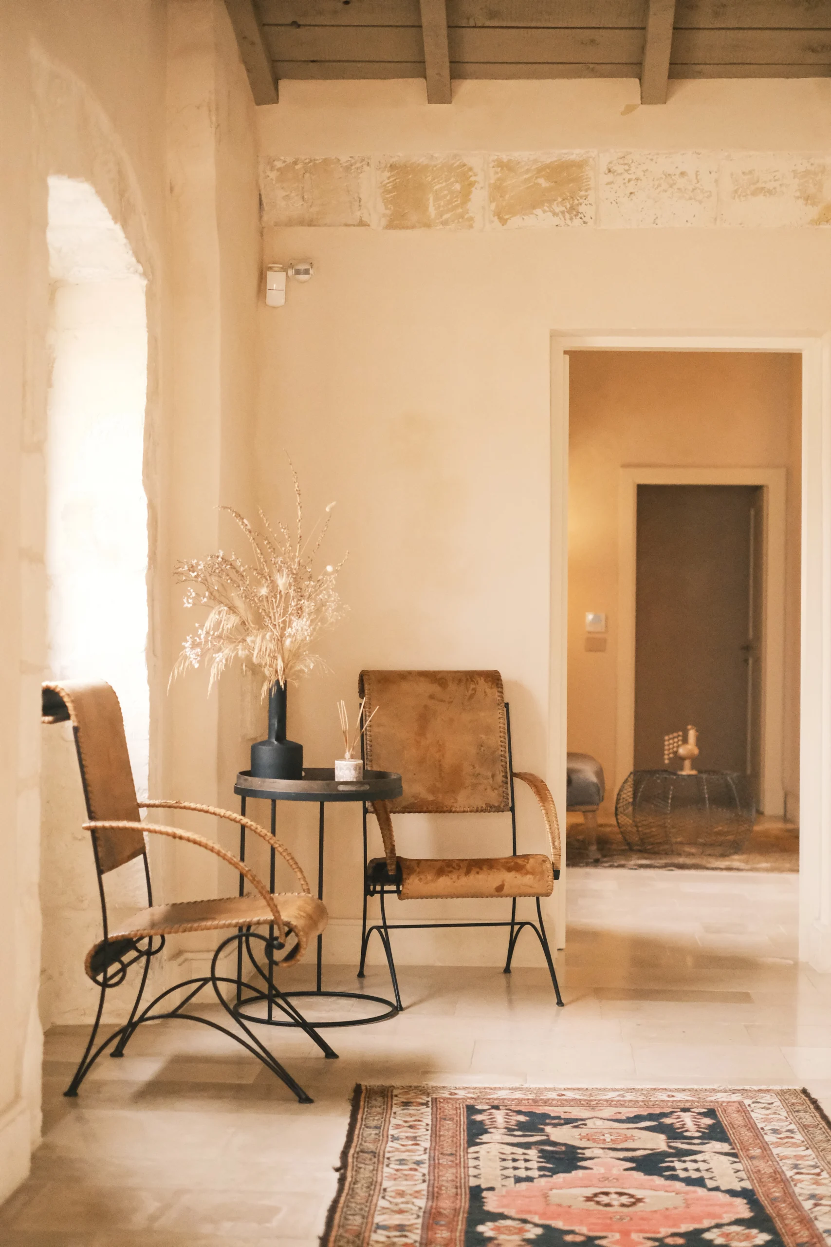 Stylish hallway lounge with vintage chairs and soft lighting in an Italian luxury villa
