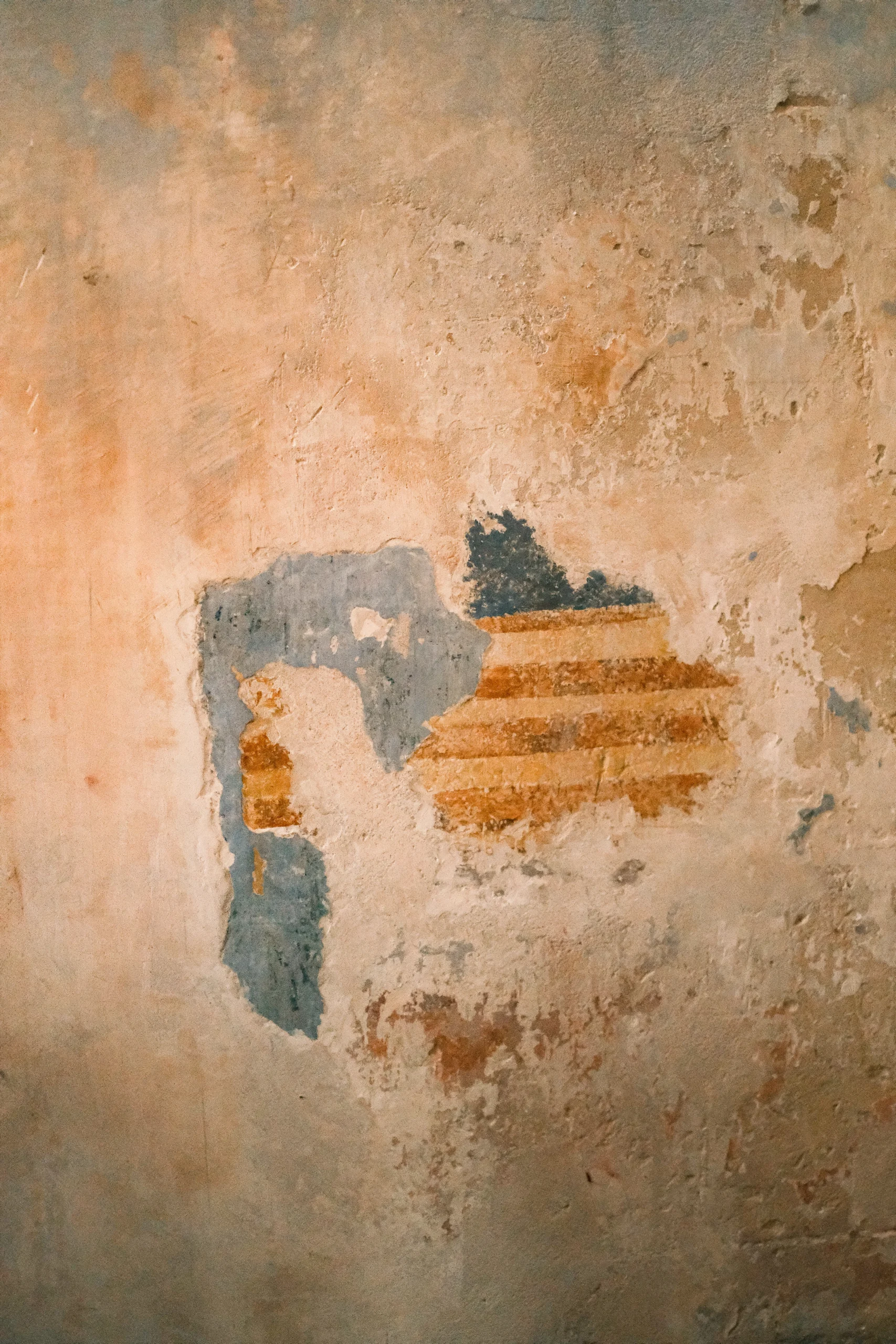 Original fresco detail on historic wall with natural patina and restored plaster in Italian palazzo