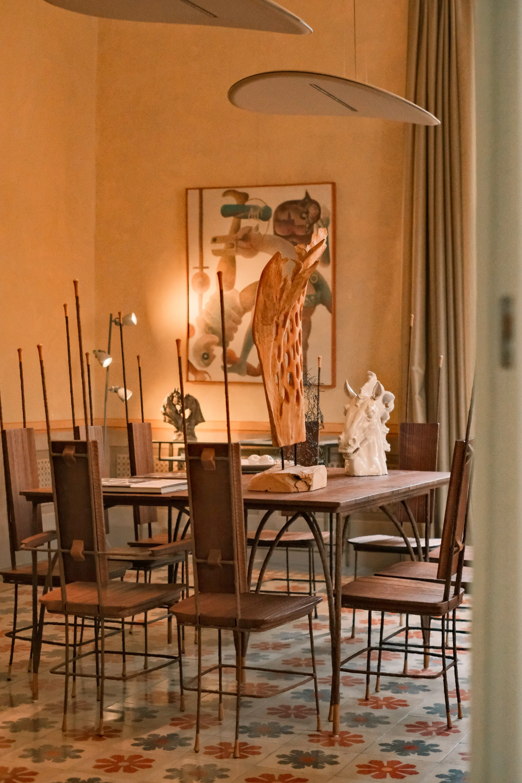 Designer dining table with sculptural centerpieces and custom lighting inside a luxury palazzo in Puglia, Italy