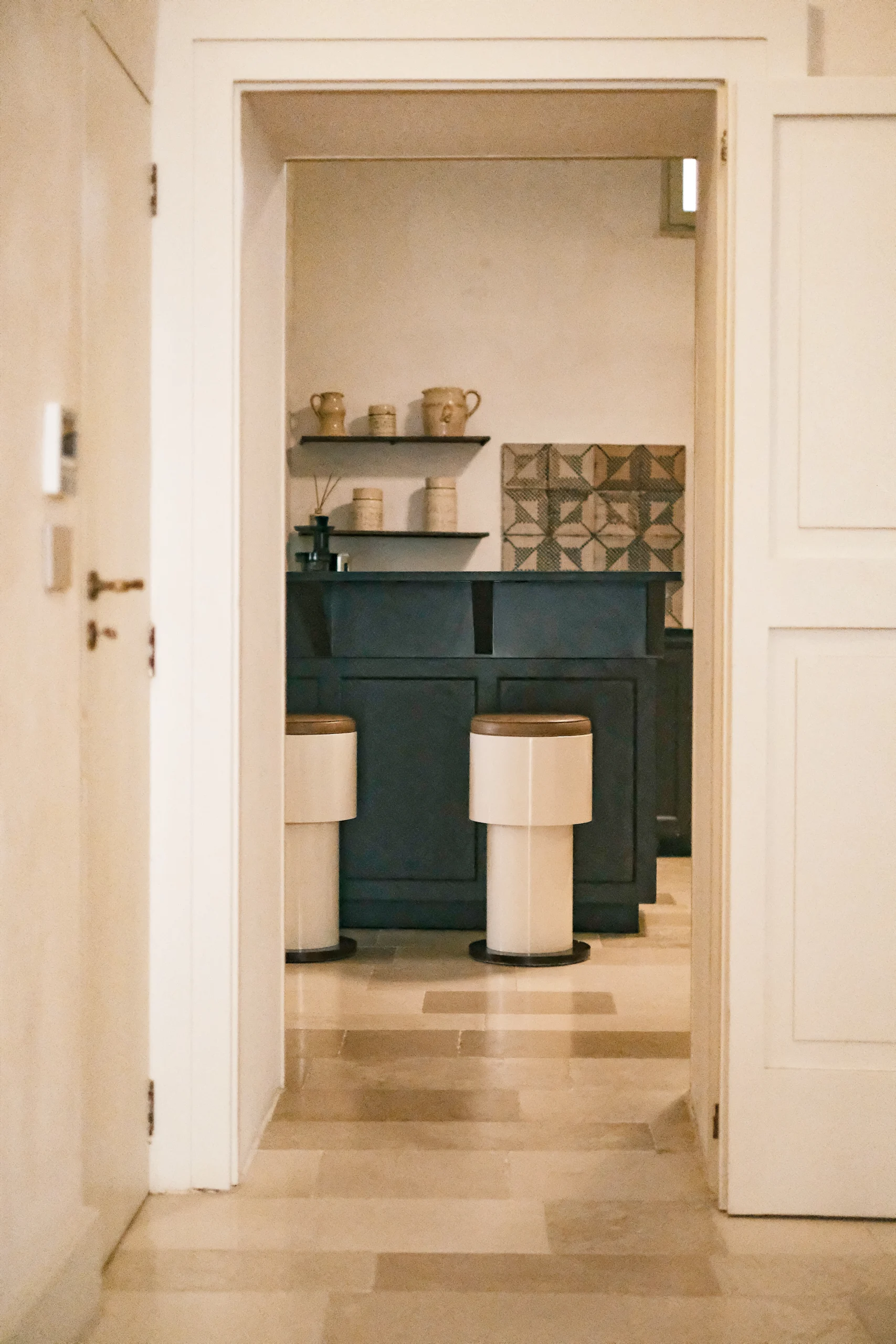Luxury kitchen in a historic palazzo featuring custom cabinetry, vaulted ceilings, and curated ceramics in Puglia