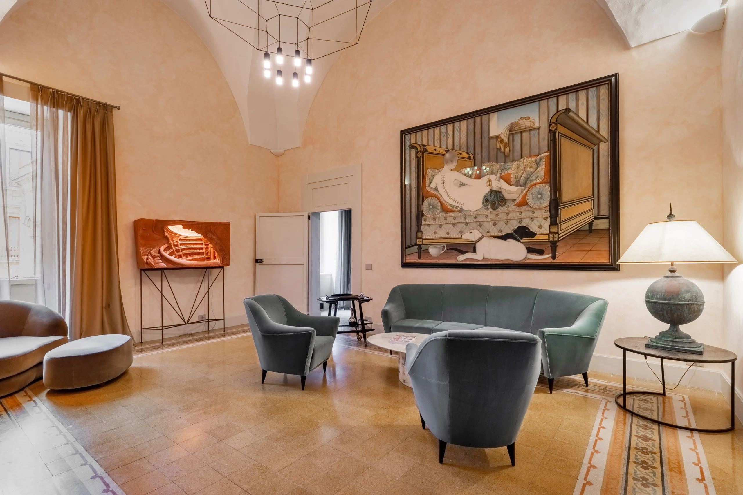 Luxury lounge area with sculptural furniture, soft lighting, and curated artworks inside a restored palazzo in Italy