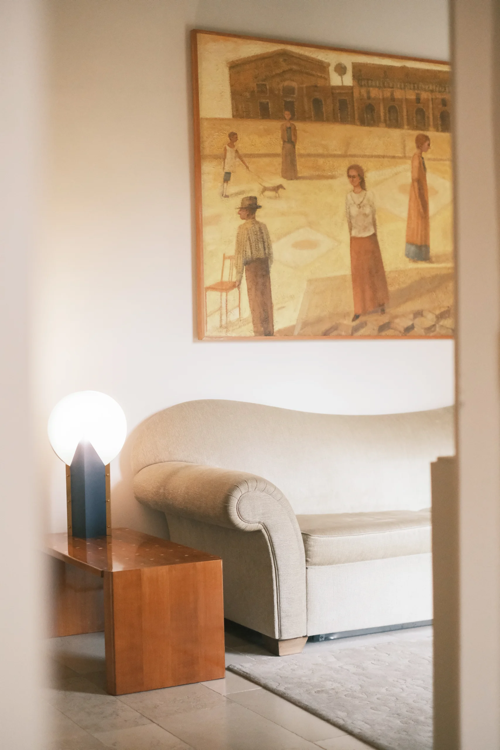 Sophisticated sitting area with designer armchairs, warm textures, and modern art in an Italian luxury home