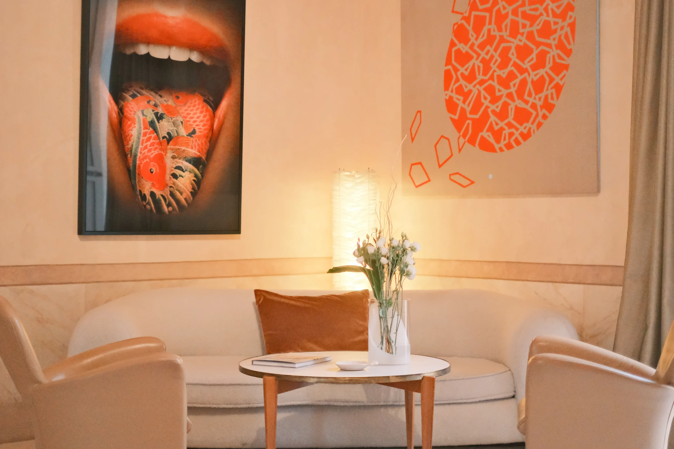 Designer lounge with contemporary seating, curated art pieces, and atmospheric lighting in an Italian luxury residence