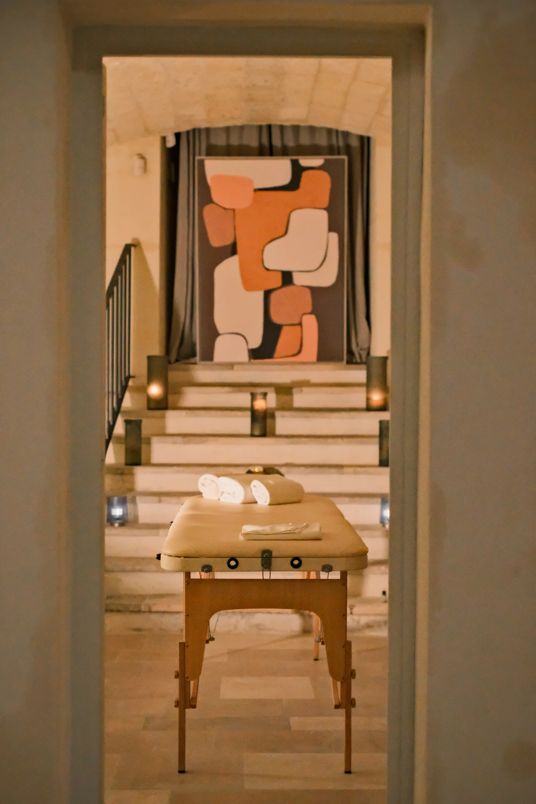 Private massage room with treatment table, candles and serene atmosphere inside a luxury villa wellness area in Puglia