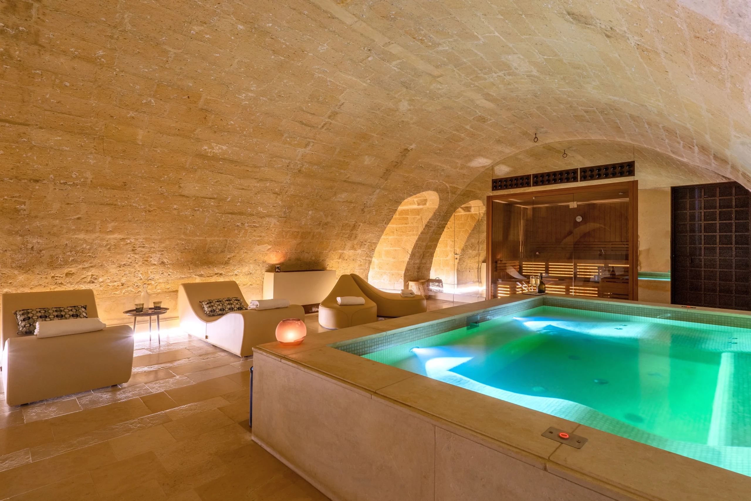 Luxury indoor pool with loungers, sauna and vaulted ceilings inside a restored palazzo