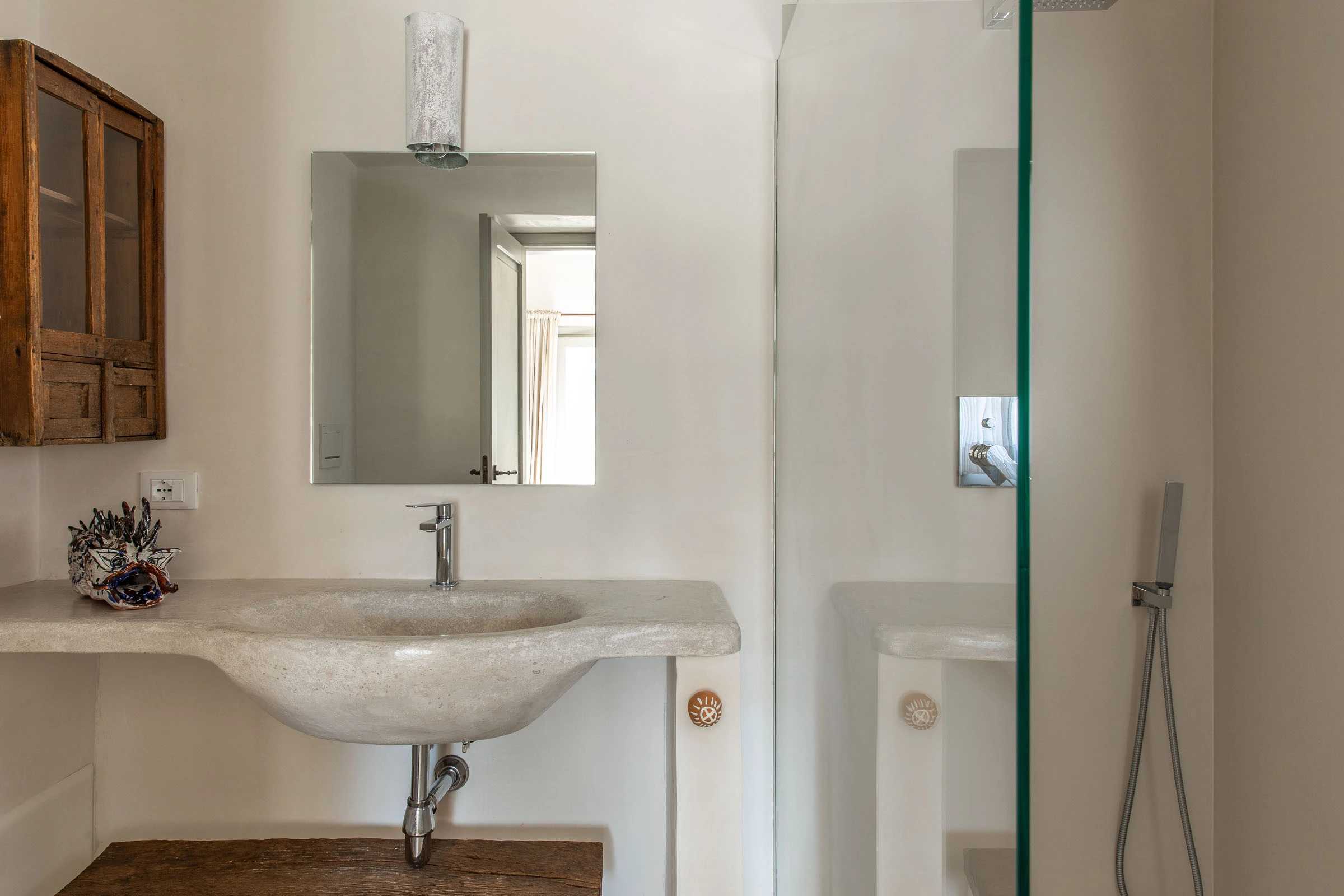 Refined bathroom sink with stone countertop and minimalist accessories at luxury villa in Puglia