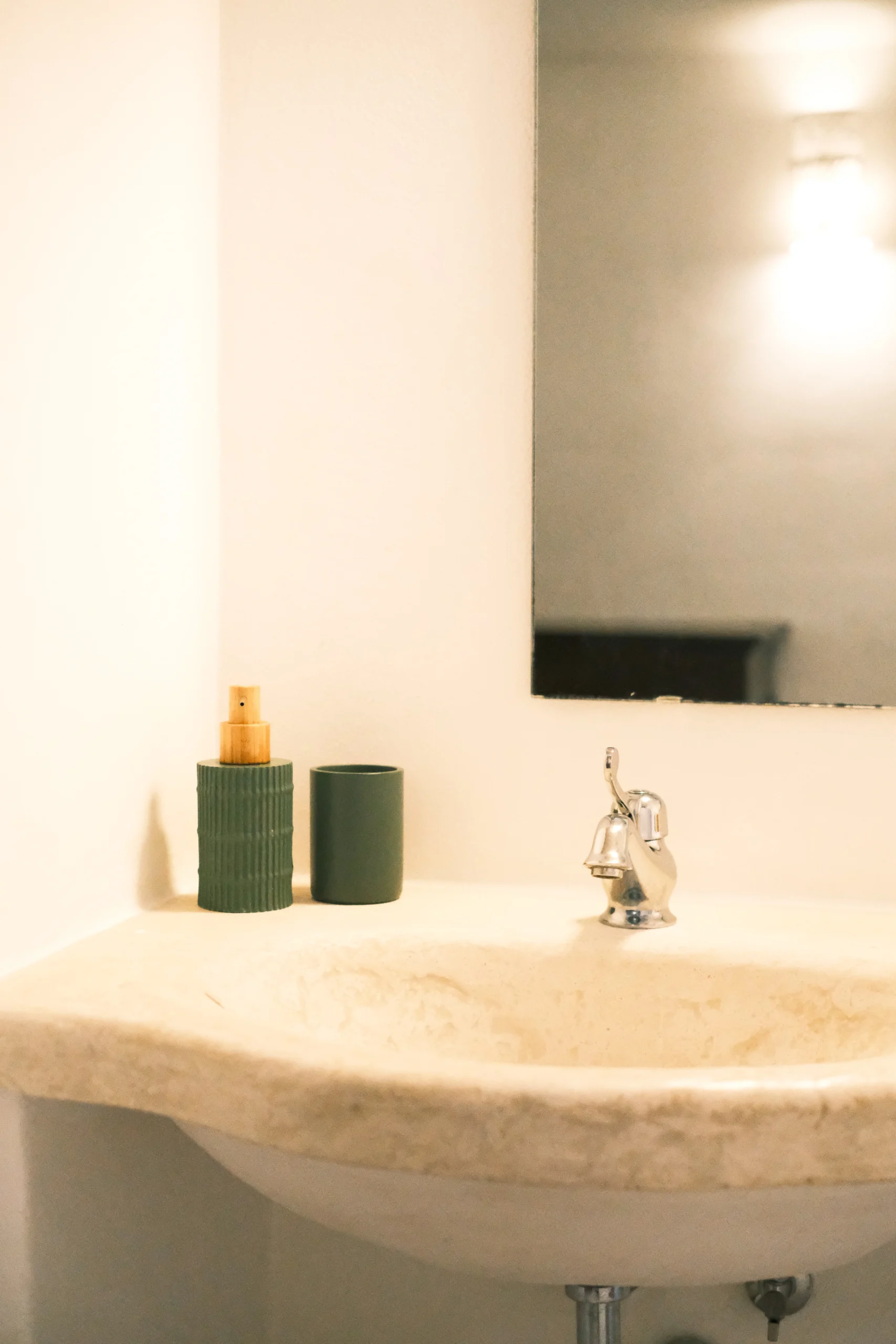 Bathroom niche detail with ceramic vase and rustic shelf inspired by local Apulian architecture