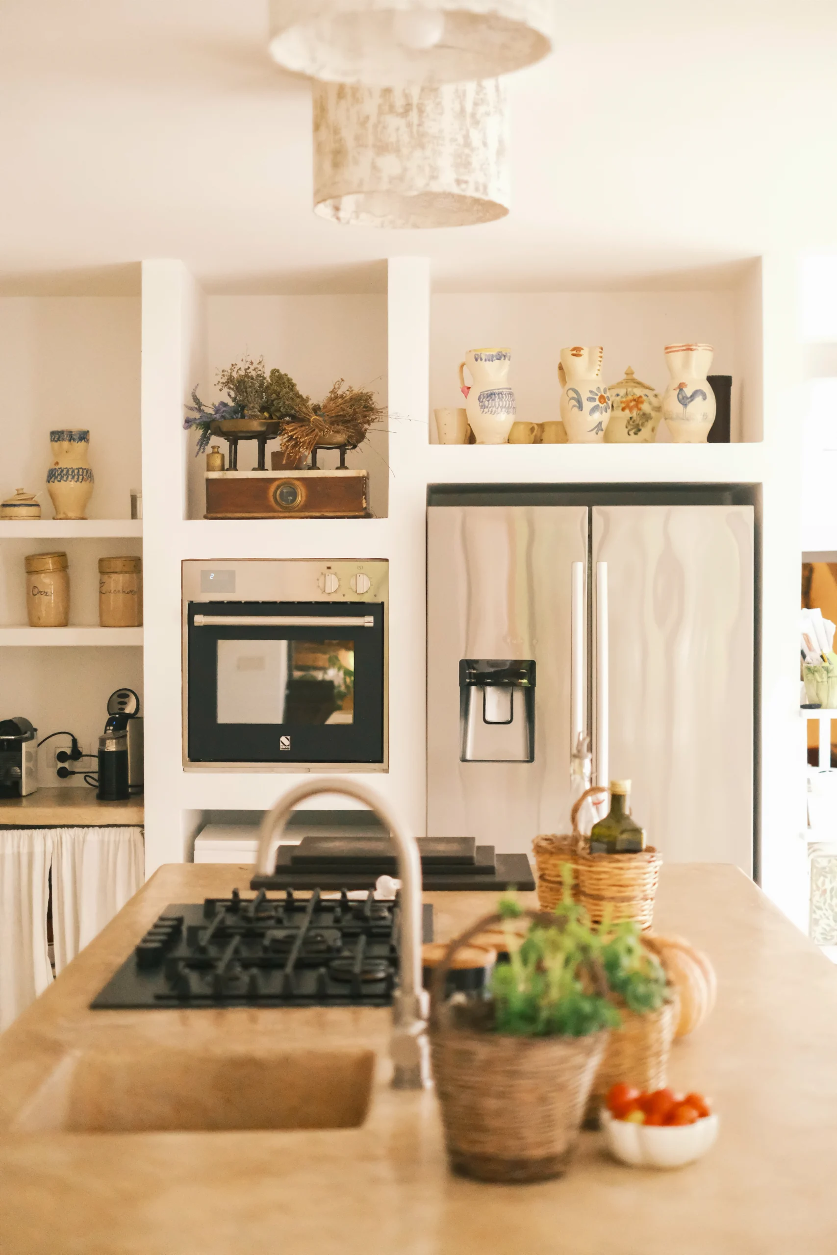 Bright fully equipped kitchen with island, oven and refrigerator in a refined Puglia countryside villa