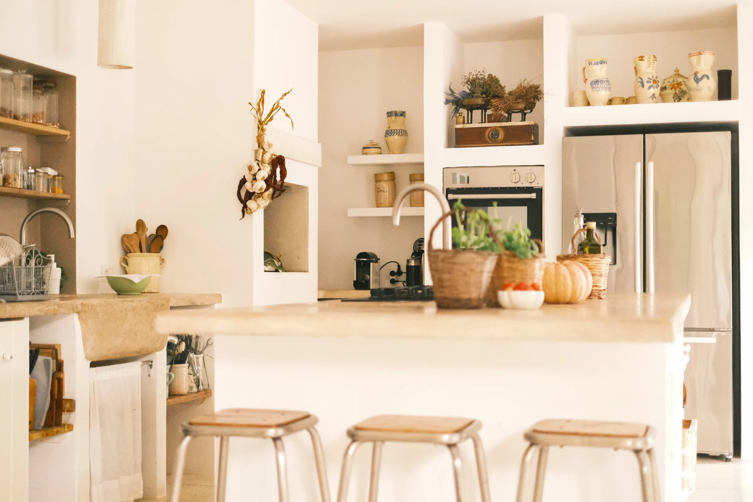 Open-plan Italian kitchen with stone countertops, built-in oven and traditional decor at Villa Caterina, Puglia