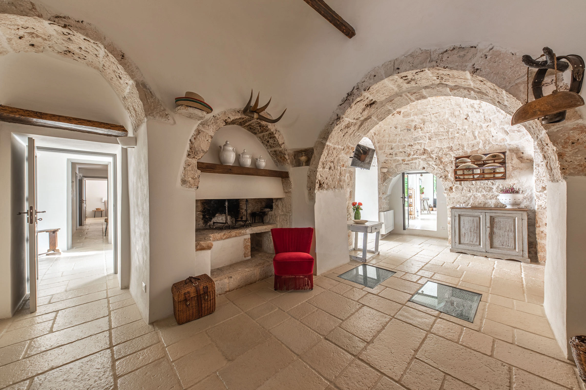 Historic stone living room in Puglia featuring vaulted ceilings, fireplace and rustic decor