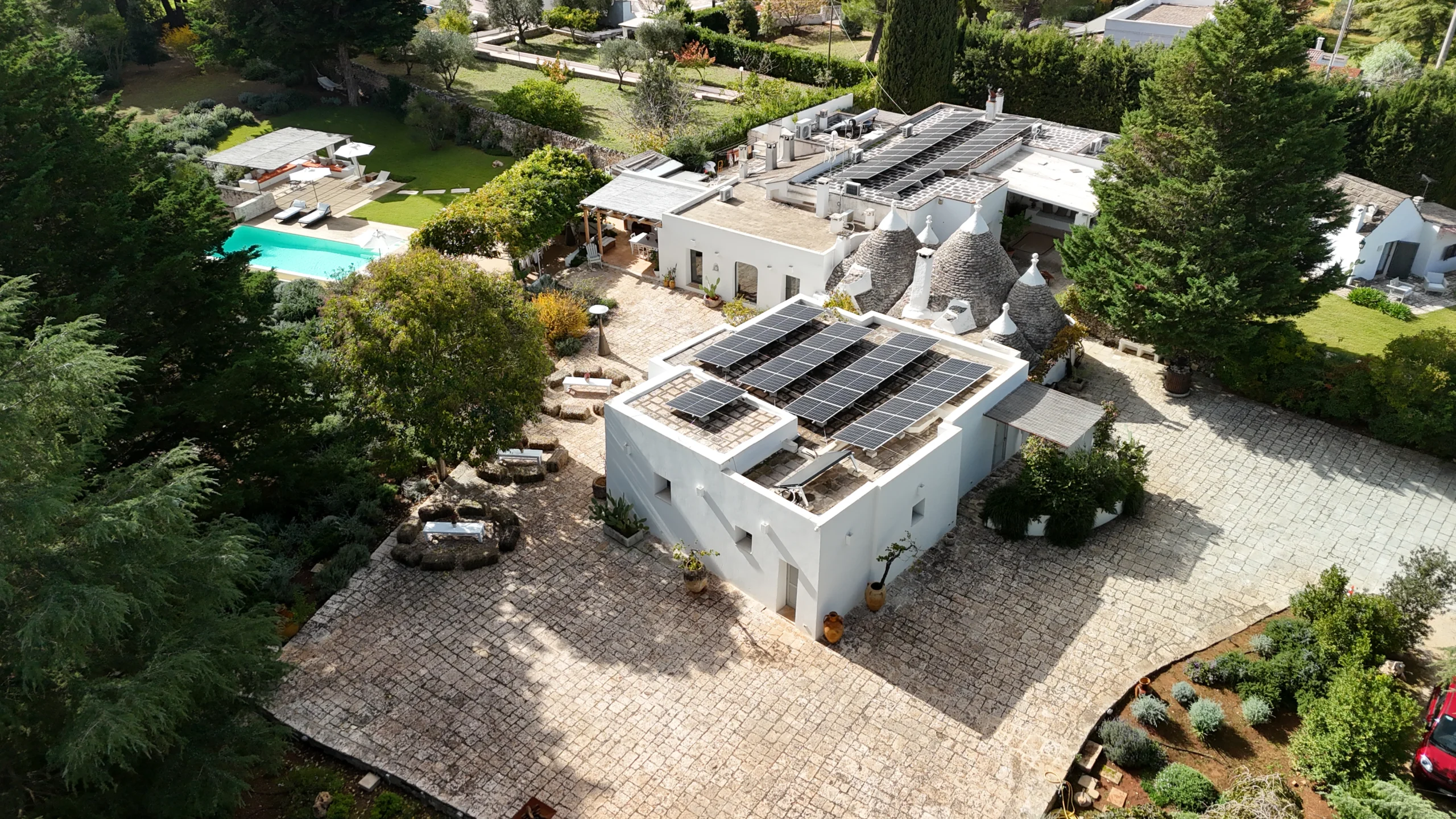 Countryside villa with pool and trulli roofs set in lush Mediterranean gardens in Puglia