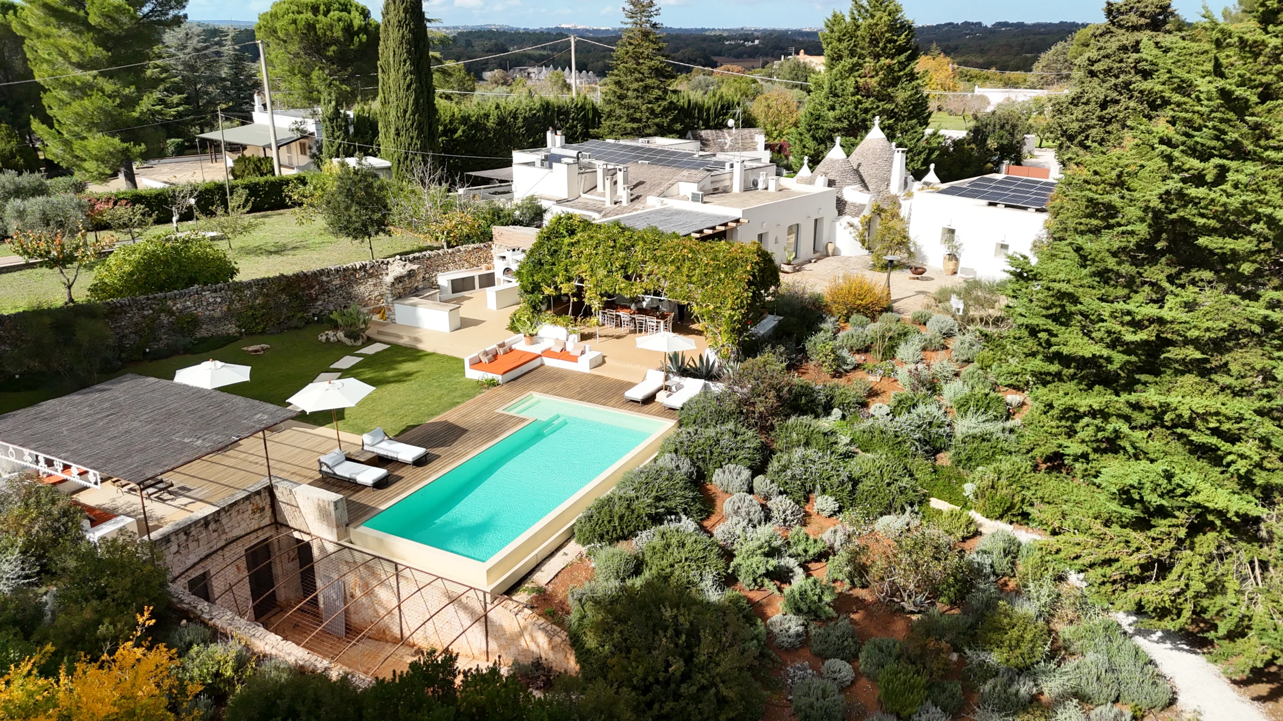 Aerial view of a luxury Apulian villa with swimming pool, solar panels and extensive gardens