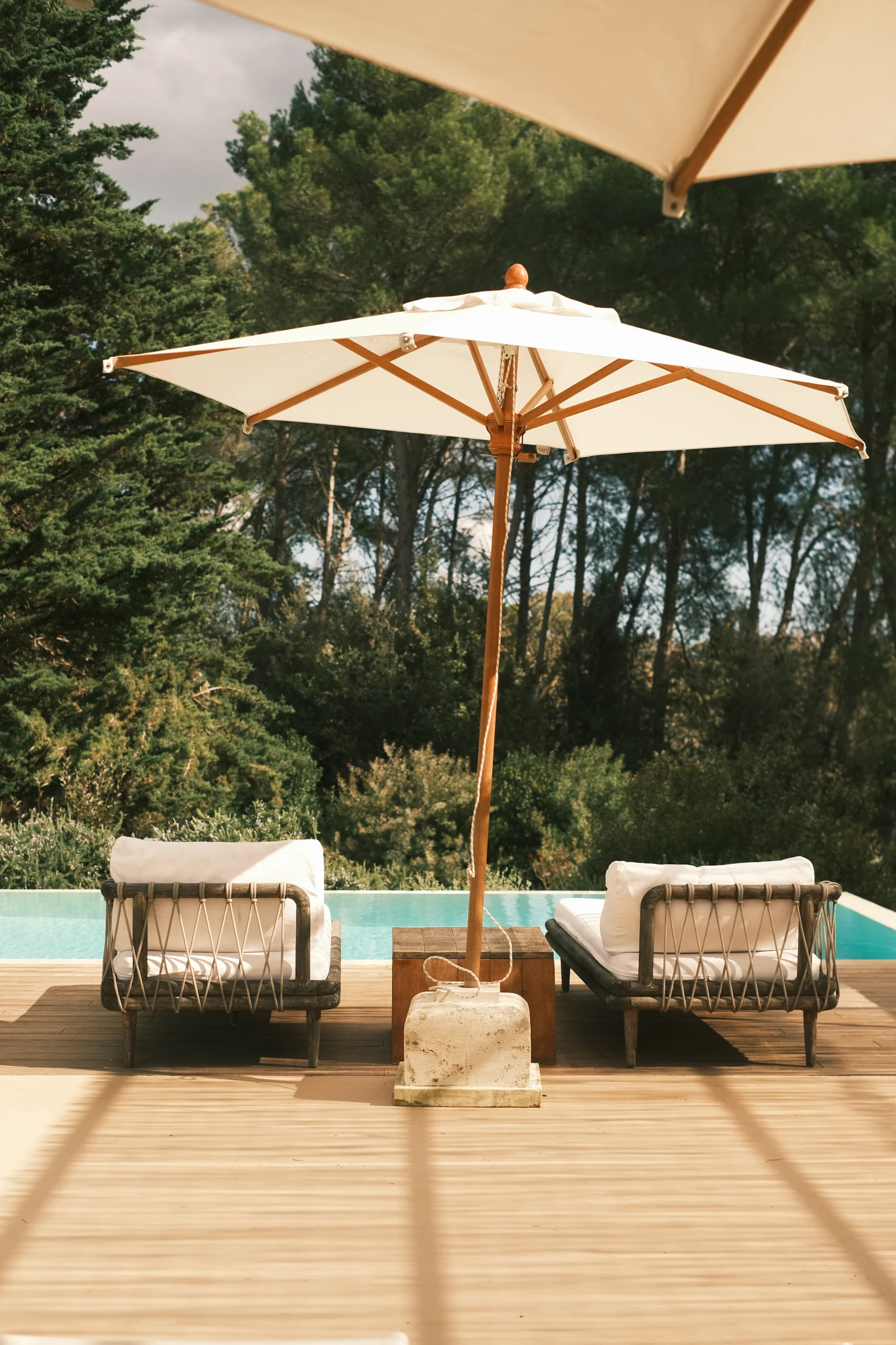 Luxury poolside loungers with white parasol overlooking a turquoise swimming pool in a private Puglia villa