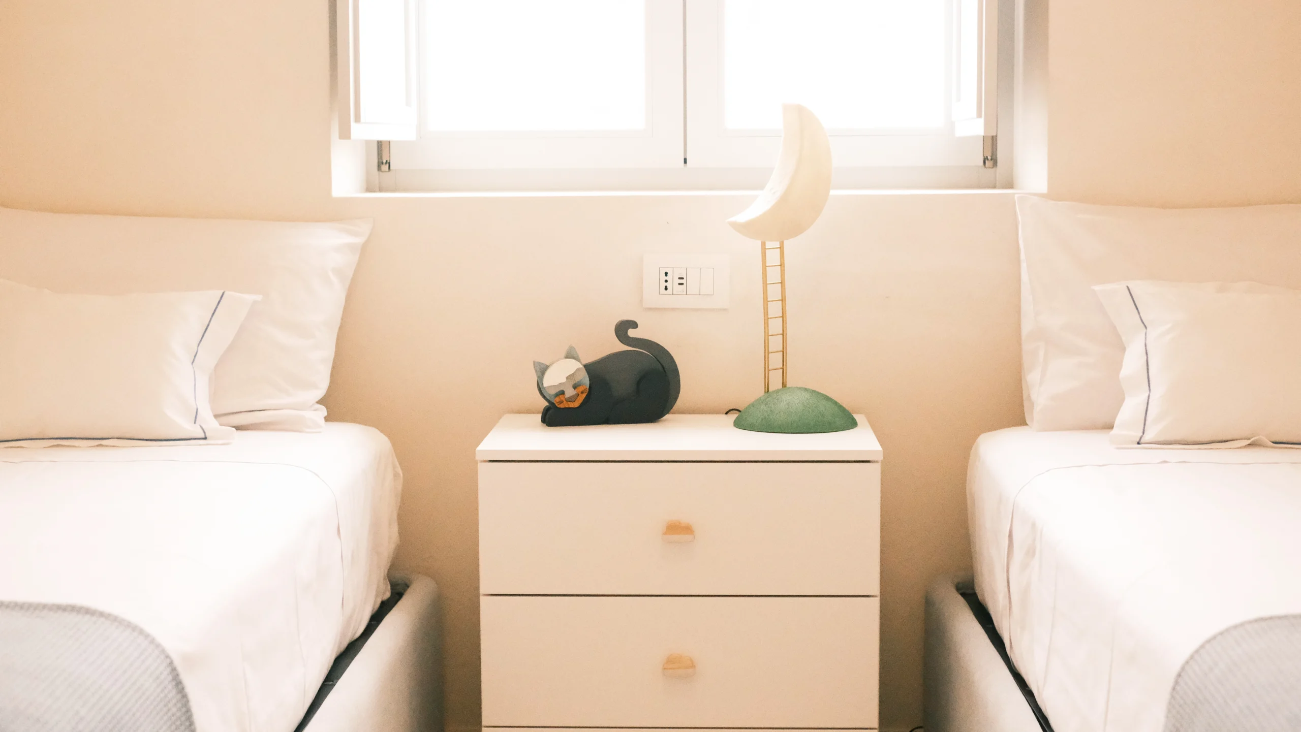 Twin bedroom with minimalist decor, white bedding and designer nightstand in a luxury villa in Puglia