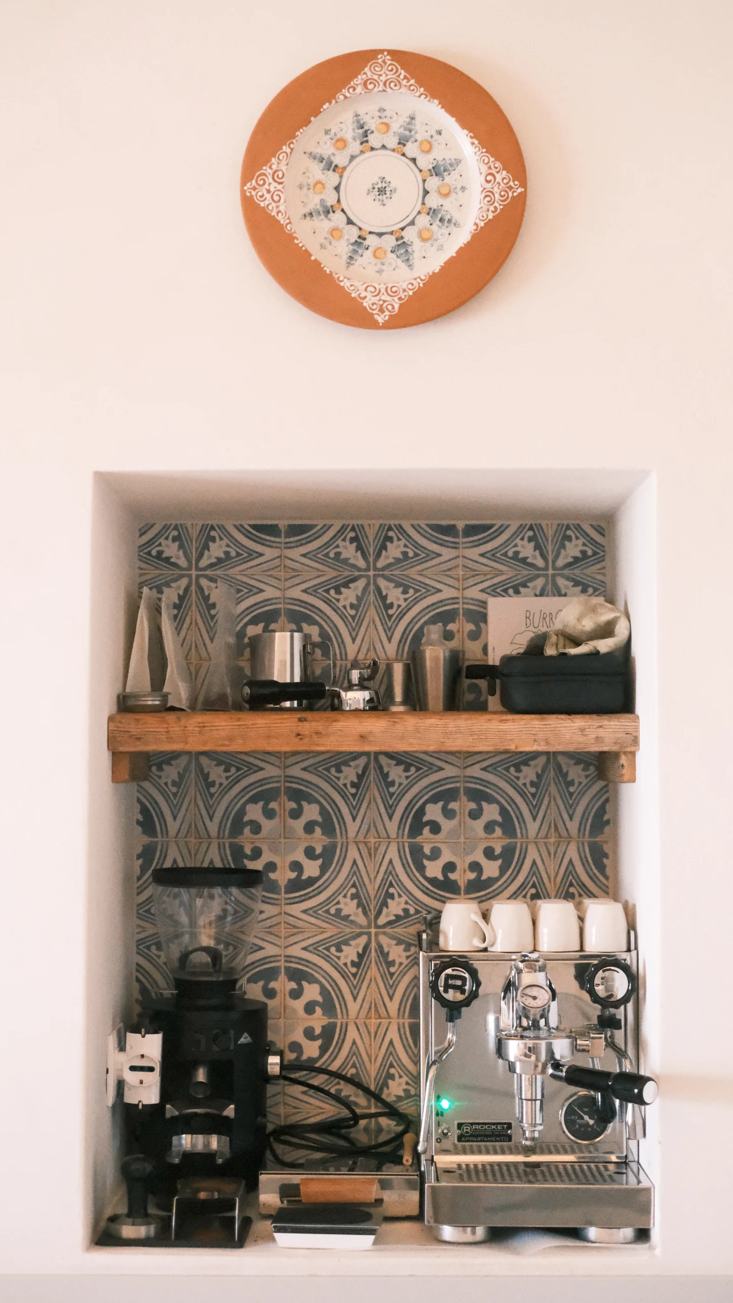 Coffee corner with espresso machine, patterned tiles and open shelving in a luxury villa kitchen in Puglia