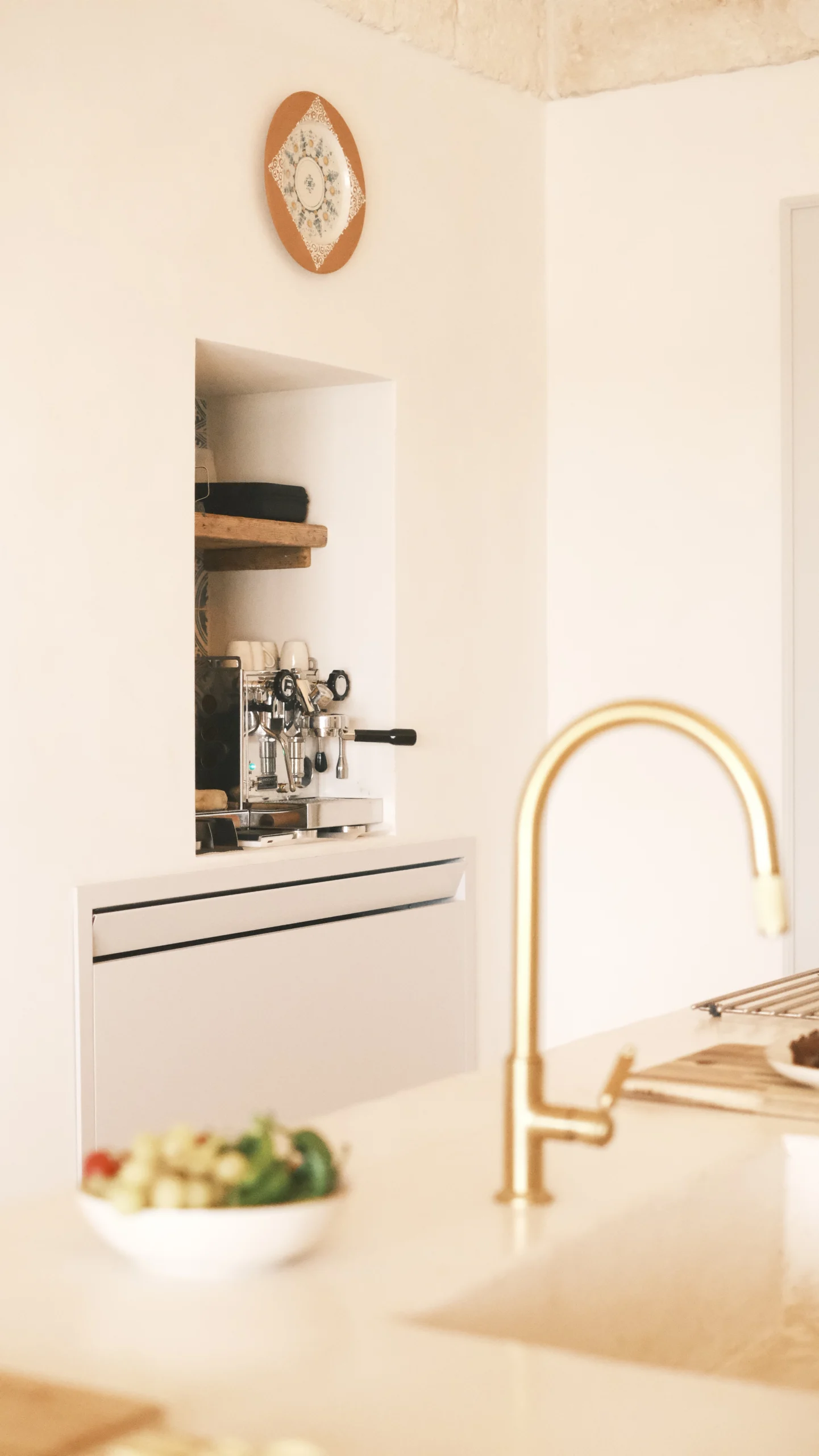 Espresso machine corner integrated into a custom niche in a luxury villa kitchen in Puglia