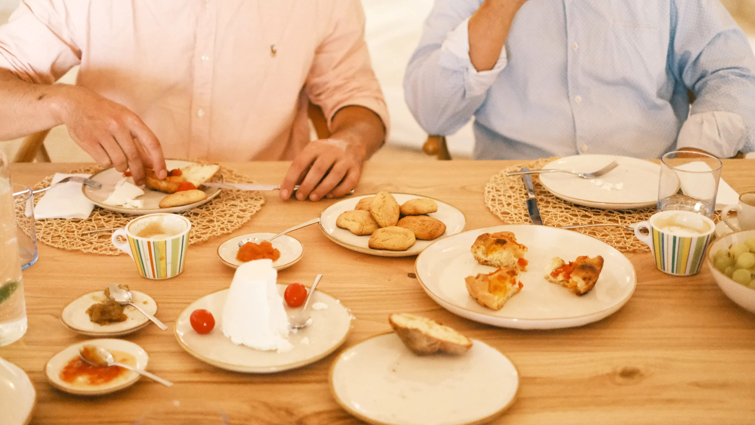 Italian breakfast table with pastries, coffee and fresh fruit served in a luxury villa in Puglia