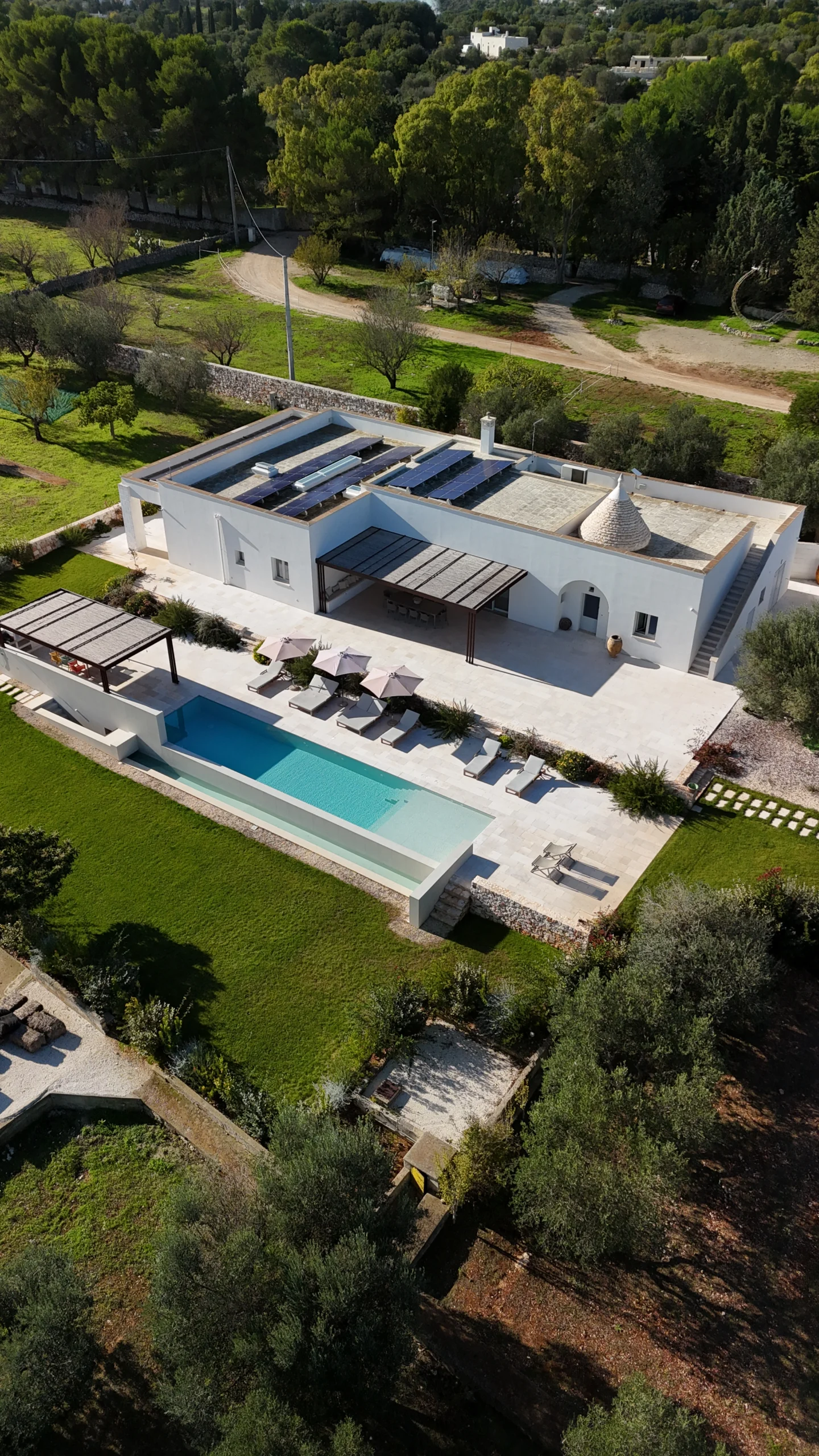 Luxury villa exterior with infinity pool, sunbeds and pergola in Puglia