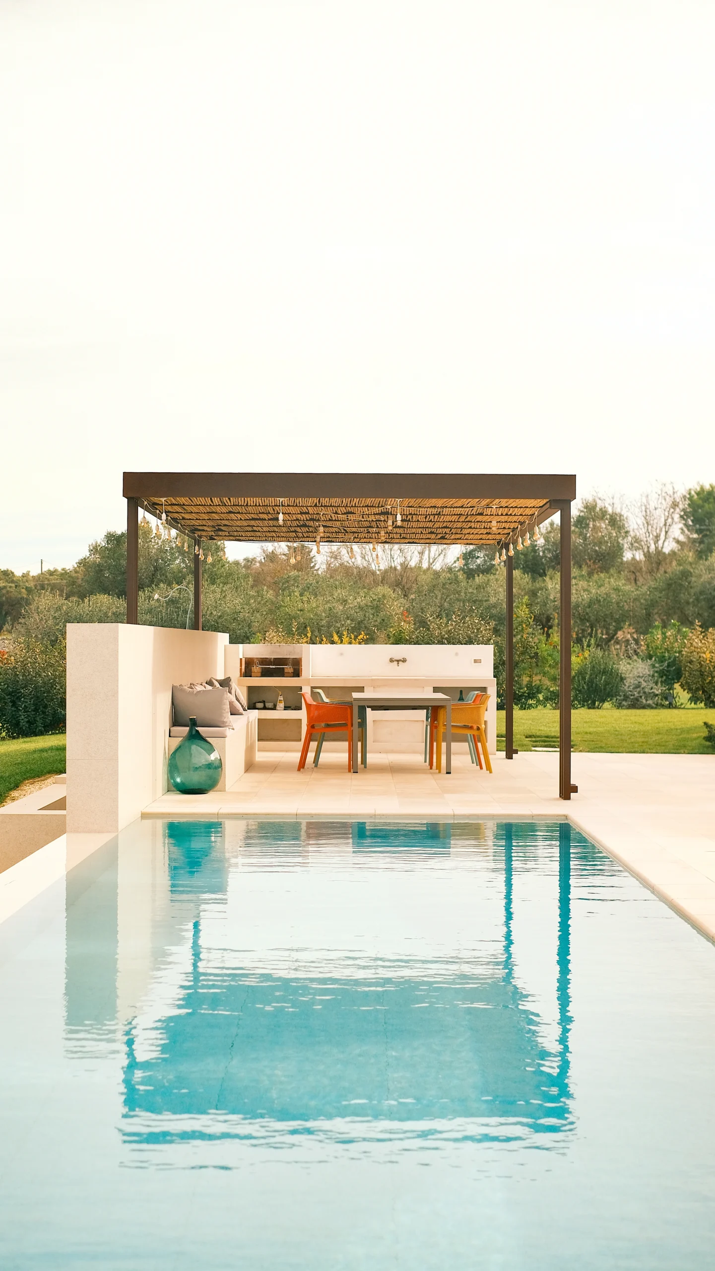 Luxury poolside with sunbeds and parasols in a private villa in Puglia