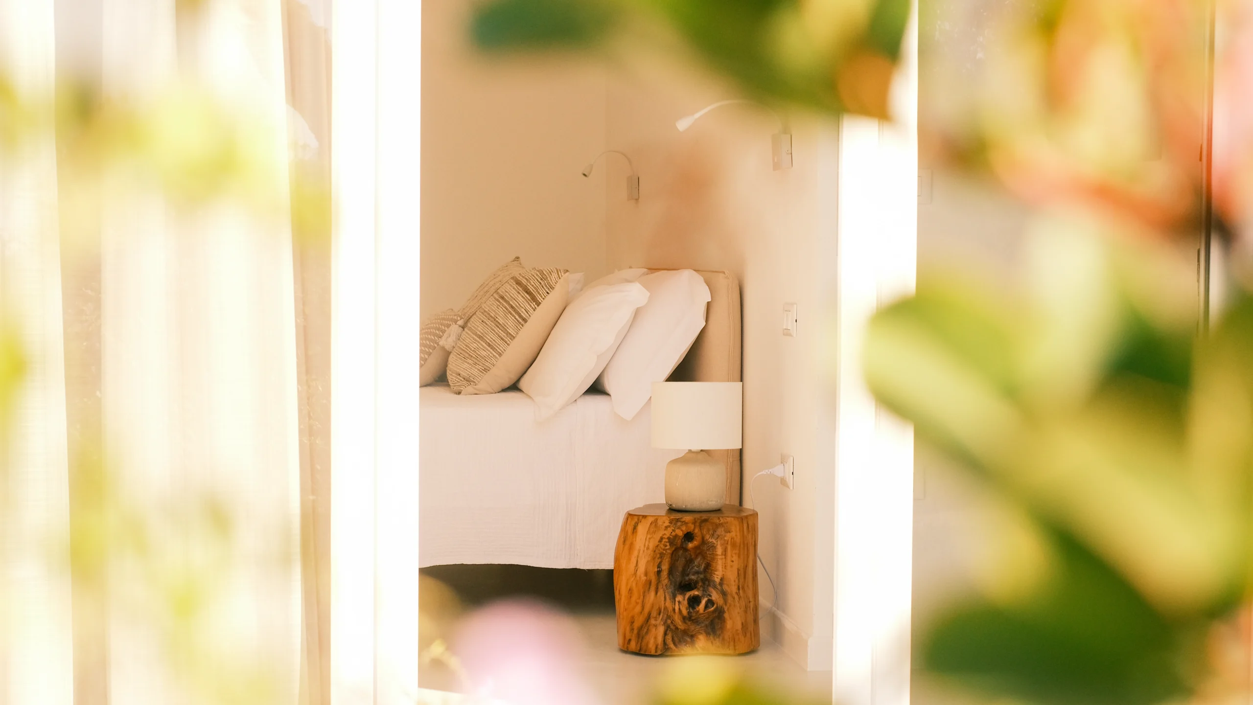 Villa Leucade luxury bedroom with white linens, soft lighting and natural wood details in Puglia villa.