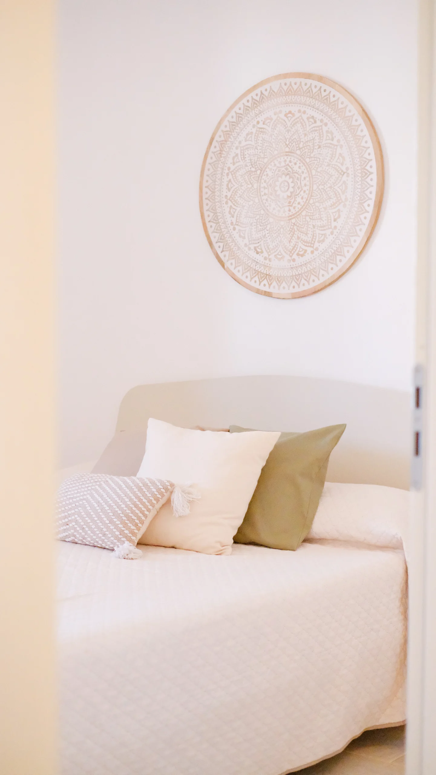 Serene bedroom with neutral tones, handmade wall decor and soft natural light at luxury villa in Puglia