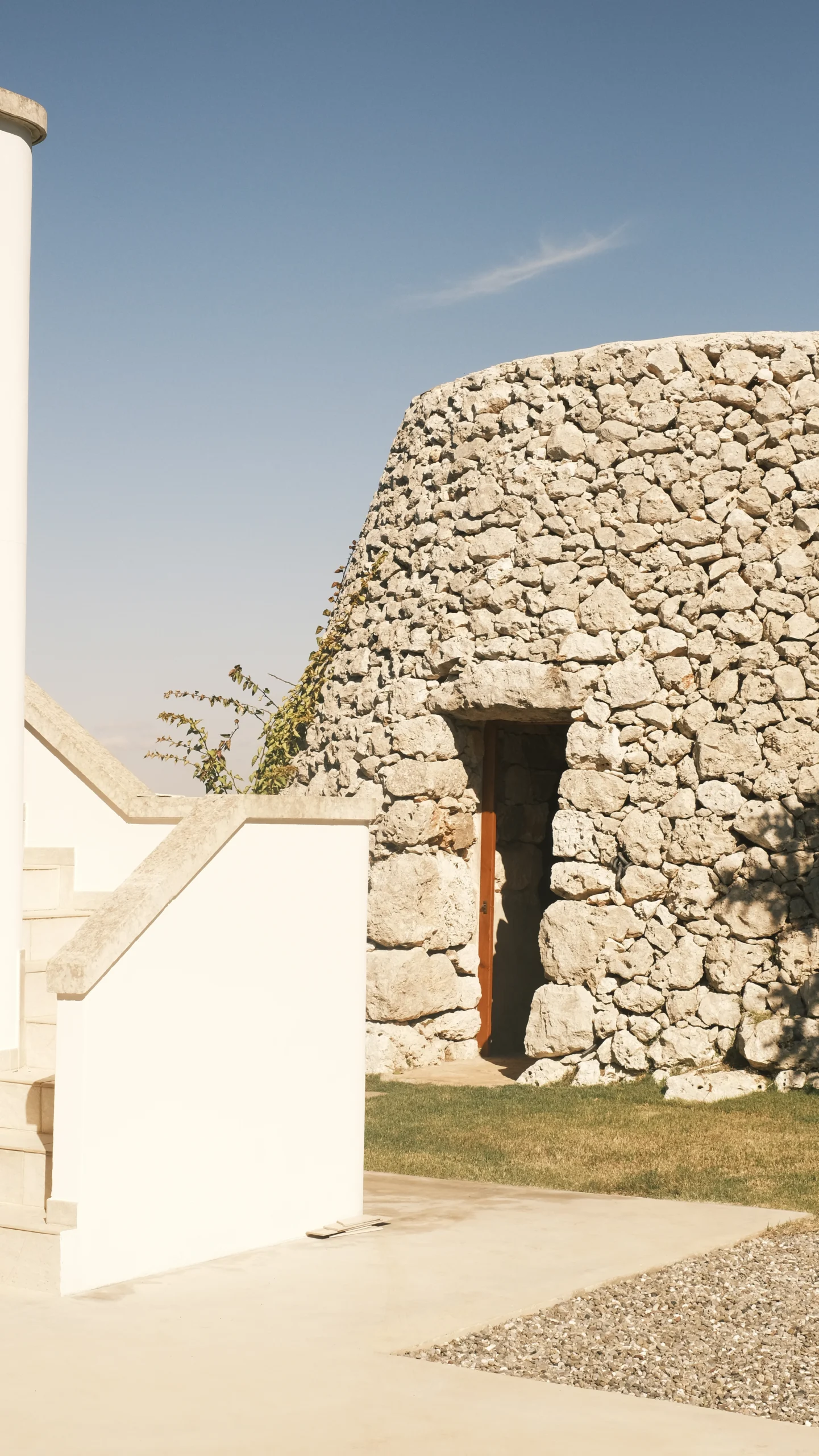 Traditional stone trullo with private entrance and white modern architecture at luxury villa in Puglia