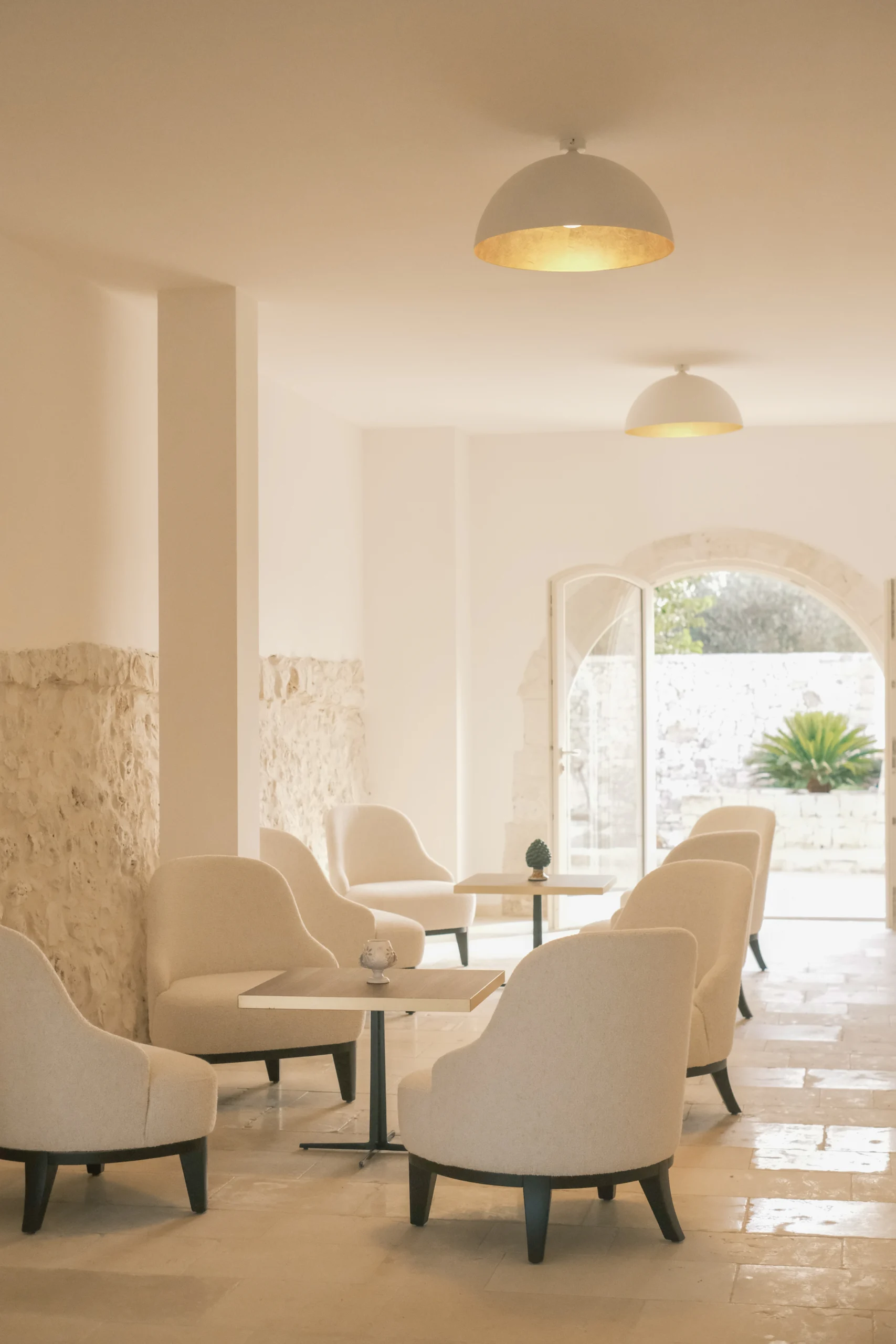 Minimalist living room with stone walls and soft seating at Villa Mira, luxury villa in Puglia
