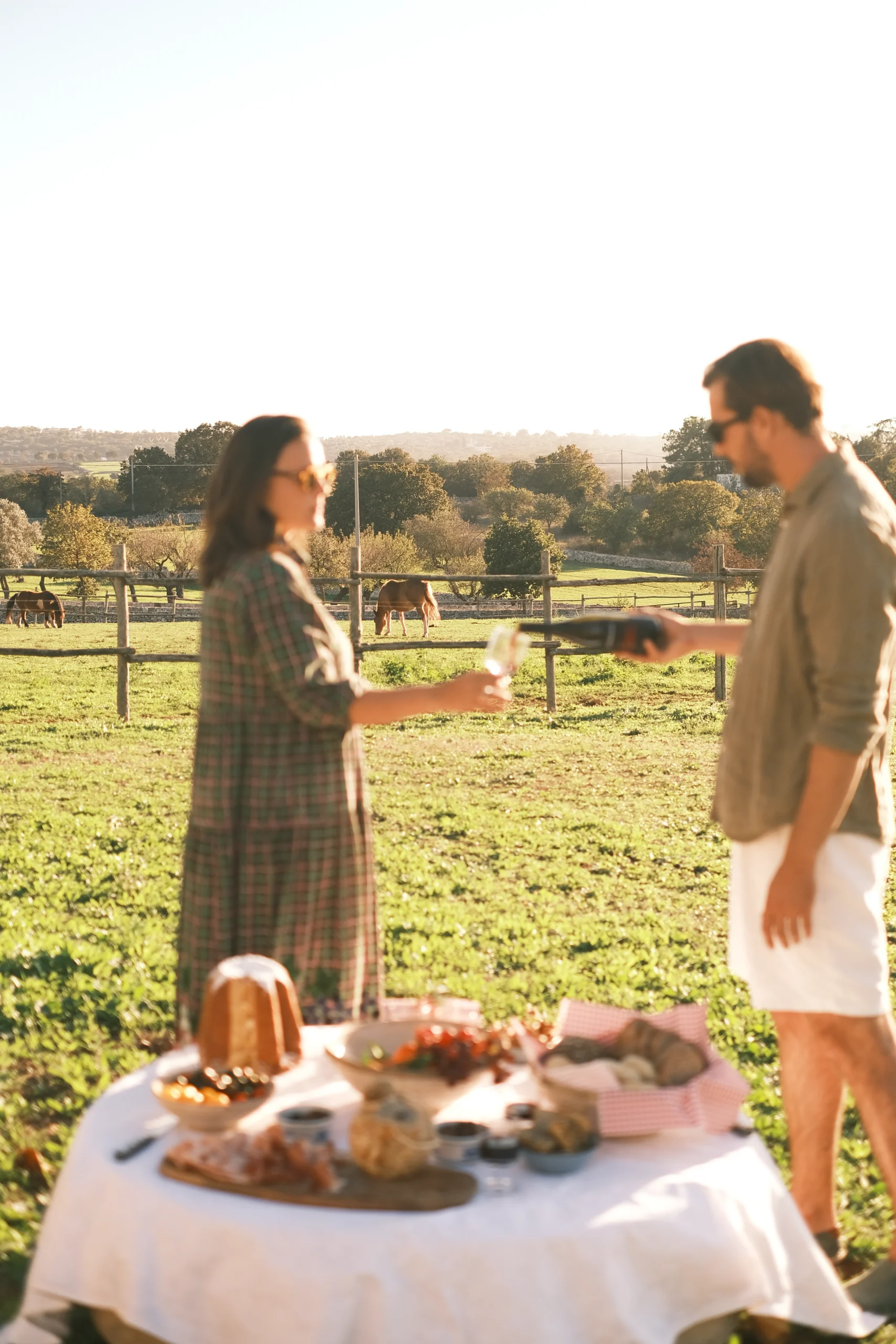 Couple enjoying a countryside aperitivo with local food at Villa Mira, authentic Puglia experience