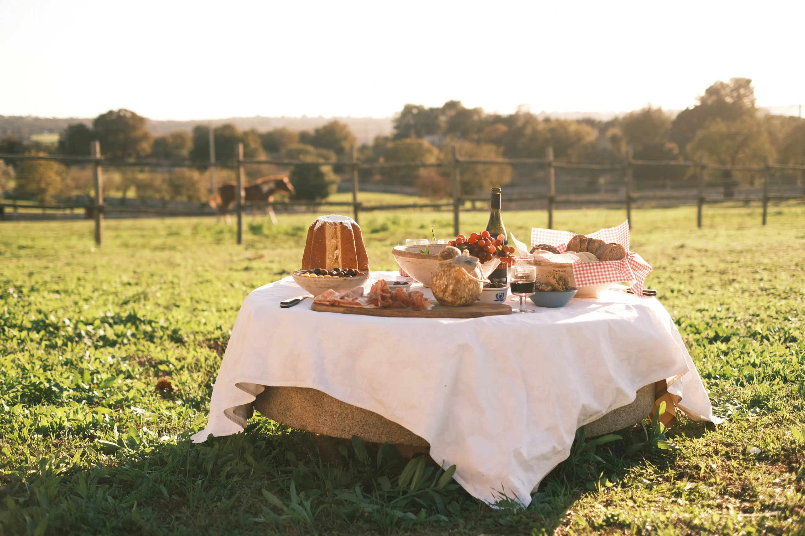 Rustic picnic setup with bread, wine, and local delicacies at Villa Mira in Puglia